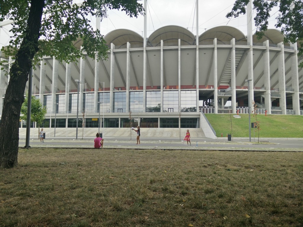 Kids playing outside stadium.