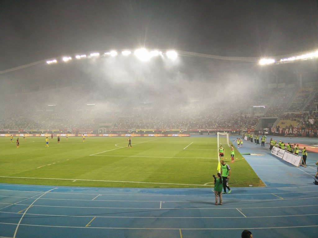 Smoke from flare in stadium.