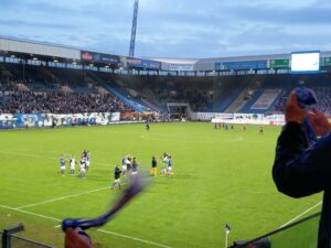 Applauding the players at the end.