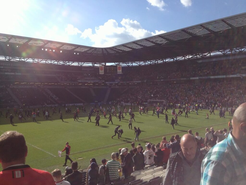 Sheffield United fans invade the pitch after securing promotion to the Championship at Stadium MK