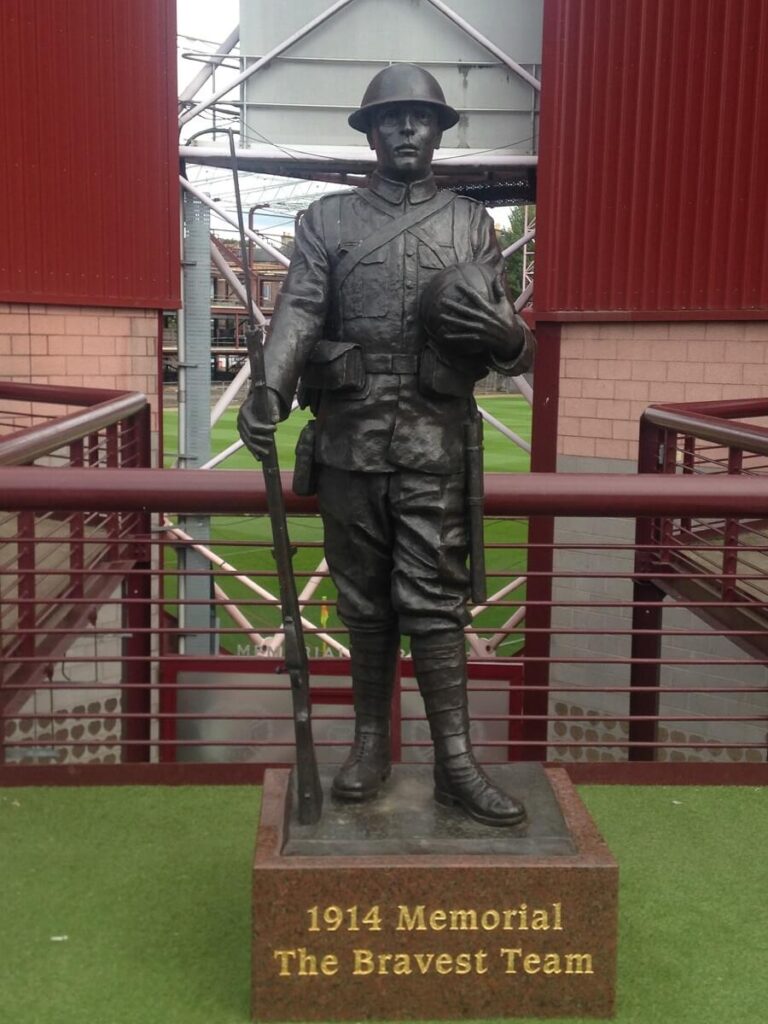 statue of a 1914 soldier with a rifle over one arm, and a football in the other at Tynecastle